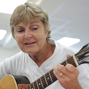 Mature woman teaching the wonders of great guitar riffs