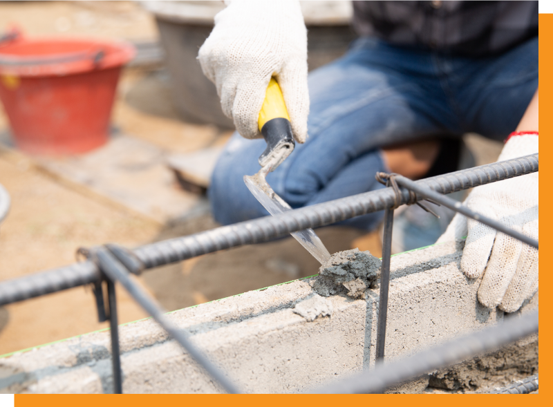 a bricklayer putting mortar on a wall